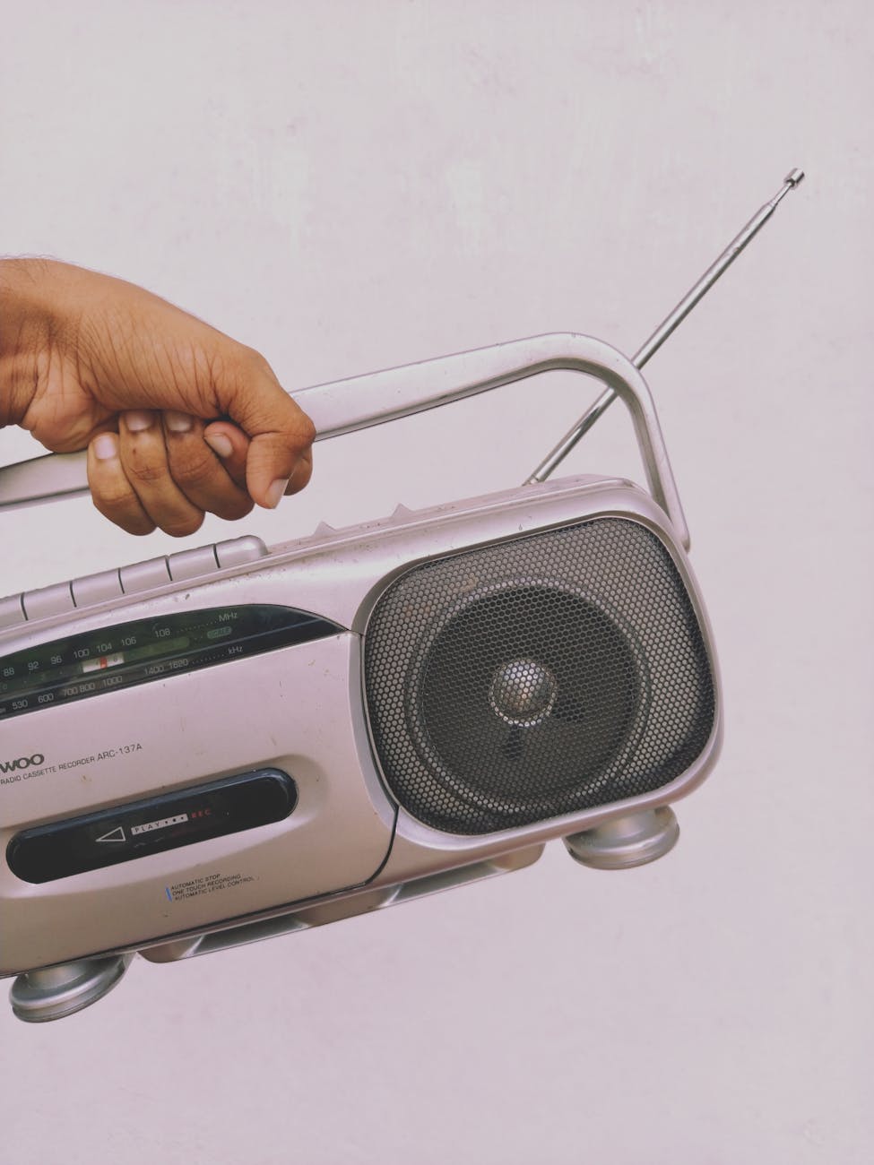 a person holding gray and black radio